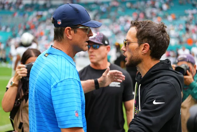 Oct 12, 2025; Miami Gardens, Florida, USA; Los Angeles Chargers head coach Jim Harbaugh greats Miami Dolphins Mike McDaniel at the game at Hard Rock Stadium. Mandatory Credit: Rich Storry-Imagn Images