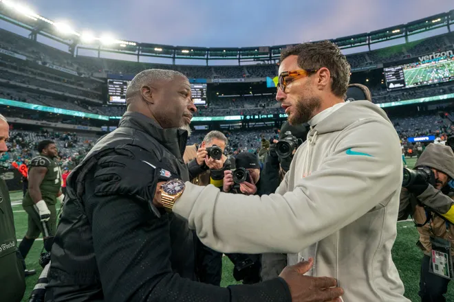 New York Jets head coach Aaron Glenn and Miami Dolphin's head coach Mike McDaniel embrace following the 34-10 Dolphins victory during a week 14 football game between the New York Jets and Miami Dolphins at MetLife Stadium on Sunday, Dec. 7, 2025.