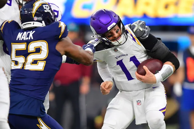 Oct 23, 2025; Inglewood, California, USA; Los Angeles Chargers linebacker Khalil Mack (52) tackles Minnesota Vikings quarterback Carson Wentz (11) during the first half at SoFi Stadium. Mandatory Credit: Gary A. Vasquez-Imagn Images