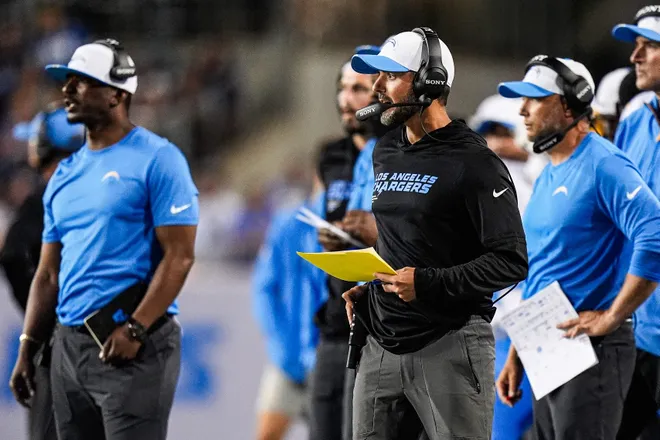 LA Chargers defensive coordinator Jesse Minter, center right, watches a play against Detroit Lions during the first half of the Hall of Fame Game at Tom Benson Hall of Fame Stadium in Canton, Ohio on Thursday, July 31, 2025.
