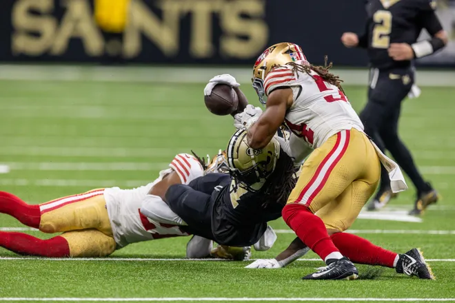Sep 14, 2025; New Orleans, Louisiana, USA; San Francisco 49ers linebacker Fred Warner (54) knocks the ball loose from New Orleans Saints running back Alvin Kamara (41) for a fumble during the second half at Caesars Superdome. Mandatory Credit: Stephen Lew-Imagn Images