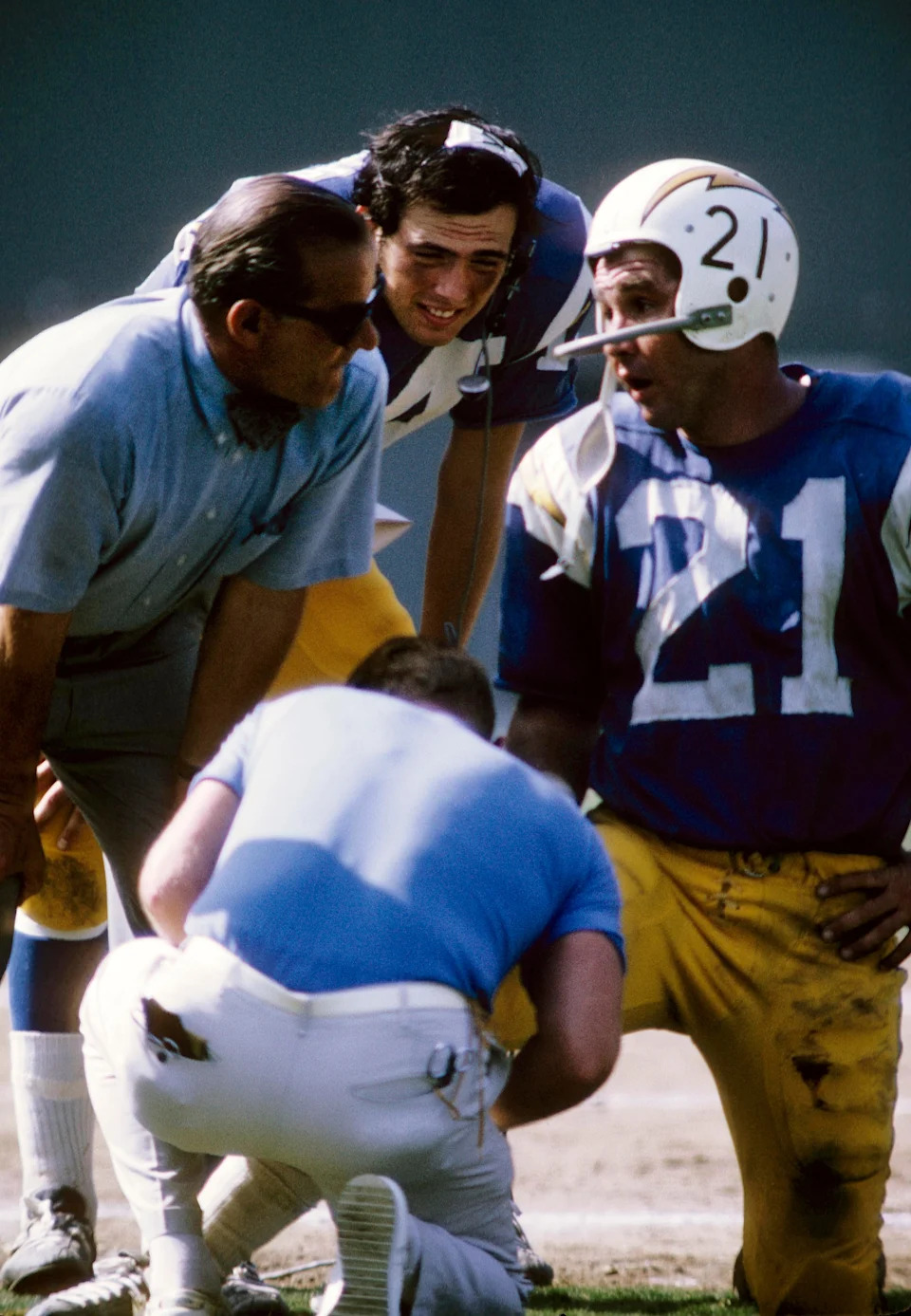 San Diego Chargers quarterback John Hadl talks to Sid Gillman and Marty Domres as he is attended to by a trainer against the Kansas City Chiefs at San Diego Stadium.