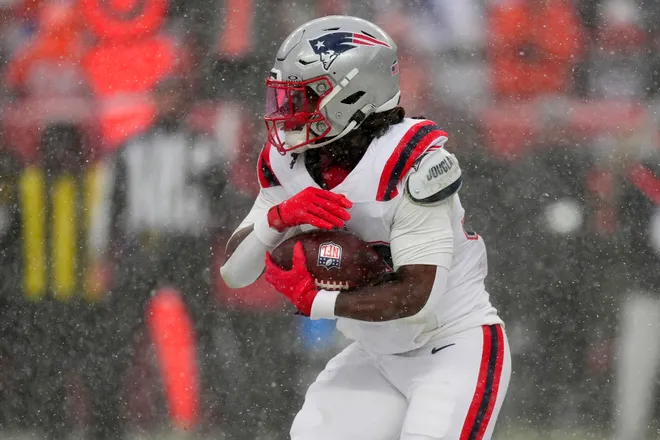 Jan 25, 2026; Denver, CO, USA; New England Patriots running back Rhamondre Stevenson (38) rushes the ball against the Denver Broncos during the second half in the 2026 AFC Championship Game at Empower Field at Mile High. Mandatory Credit: Ron Chenoy-Imagn Images