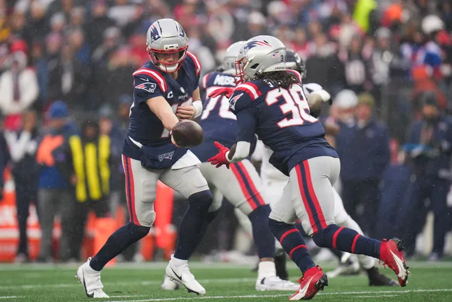 Jan 18, 2026; Foxborough, MA, USA; New England Patriots quarterback Drake Maye (10) hands off the ball to running back Rhamondre Stevenson (38) in the first quarter of in an AFC Divisional Round game against the Houston Texans at Gillette Stadium. Mandatory Credit: David Butler II-Imagn Images