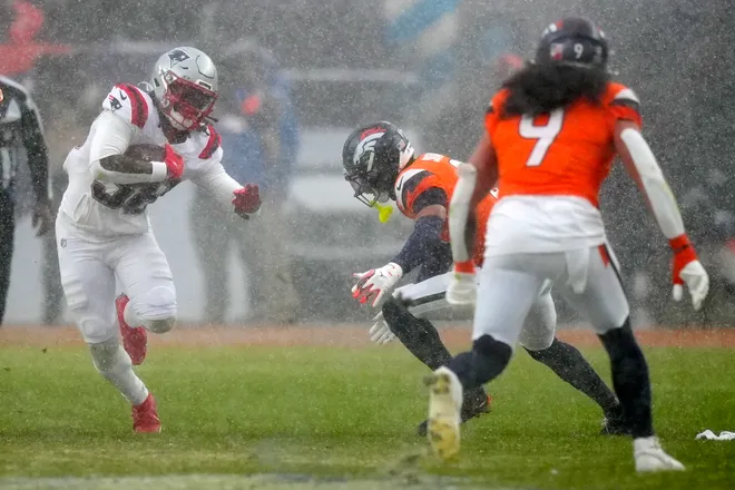 Jan 25, 2026; Denver, CO, USA; New England Patriots running back Rhamondre Stevenson (38) rushes the ball against the Denver Broncos during the second half in the 2026 AFC Championship Game at Empower Field at Mile High. Mandatory Credit: Ron Chenoy-Imagn Images
