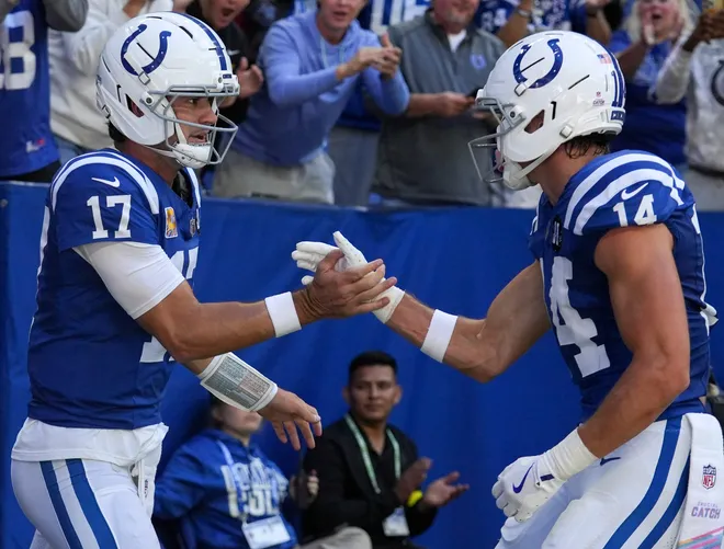 Indianapolis Colts quarterback Daniel Jones (17) celebrates with wide receiver Alec Pierce (14) after Jones scores a touchdown during a game against the Arizona Cardinals on Sunday, Oct. 12, 2025, at Lucas Oil Stadium in Indianapolis
