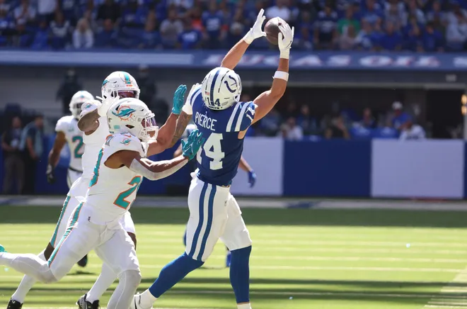 Sep 7, 2025; Indianapolis, Indiana, USA; Indianapolis Colts wide receiver Alec Pierce (14) makes a catch against Miami Dolphins cornerback Rasul Douglas (26) and safety Minkah Fitzpatrick (29) during the second half at Lucas Oil Stadium. Mandatory Credit: Trevor Ruszkowski-Imagn Images