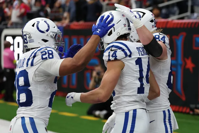 Jan 4, 2026; Houston, Texas, USA; Indianapolis Colts wide receiver Alec Pierce (14) reacts with running back Jonathan Taylor (28) and tight end Tyler Warren (84) after catching a touchdown against the Houston Texans during the first half at NRG Stadium. Mandatory Credit: Thomas Shea-Imagn Images
