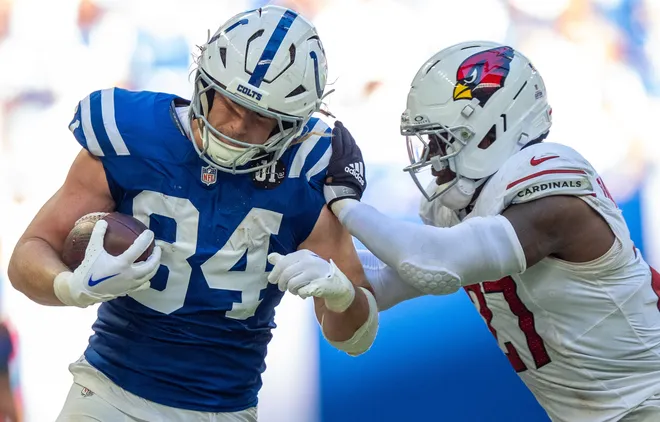 Indianapolis Colts tight end Tyler Warren (84) is drove out of bounds Sunday, Oct. 12, 2025, by Arizona Cardinals linebacker Akeem Davis-Gaither (27) at Lucas Oil Stadium in Indianapolis.
