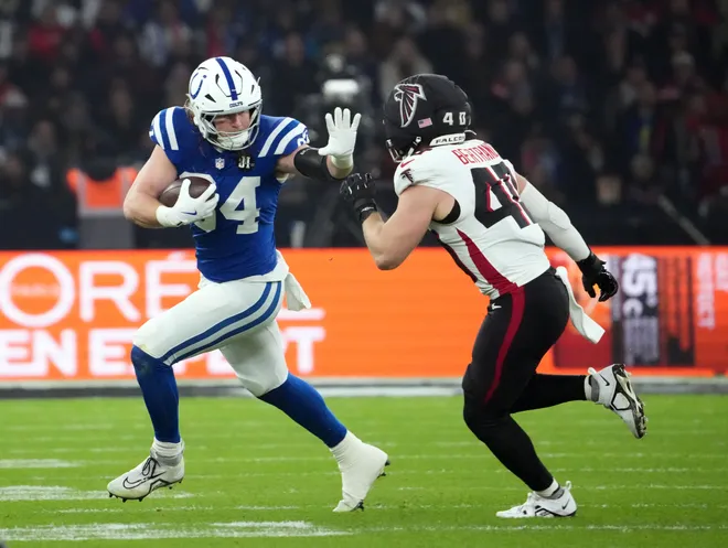 Nov 9, 2025; Berlin, Germany; Indianapolis Colts tight end Tyler Warren (84) runs against Atlanta Falcons linebacker JD Bertrand (40) during the NFL Berlin Game at Olympic Stadium. Mandatory Credit: Kirby Lee-Imagn Images