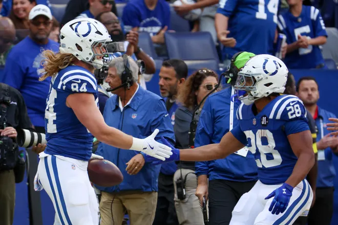 Oct 12, 2025; Indianapolis, Indiana, USA; Indianapolis Colts tight end Tyler Warren (84) celebrates with running back Jonathan Taylor (28) after a reception against the Arizona Cardinals during the first quarter of the game at Lucas Oil Stadium. Mandatory Credit: Trevor Ruszkowski-Imagn Images