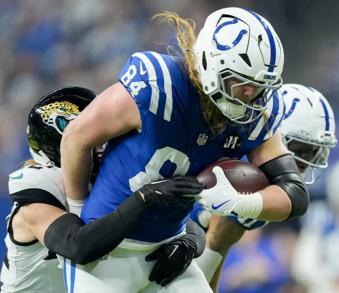 Indianapolis Colts tight end Tyler Warren (84) works to break free from Jacksonville Jaguars safety Andrew Wingard (42) on Sunday, Dec. 28, 2025, during a game against the Jacksonville Jaguars at Lucas Oil Stadium in Indianapolis.