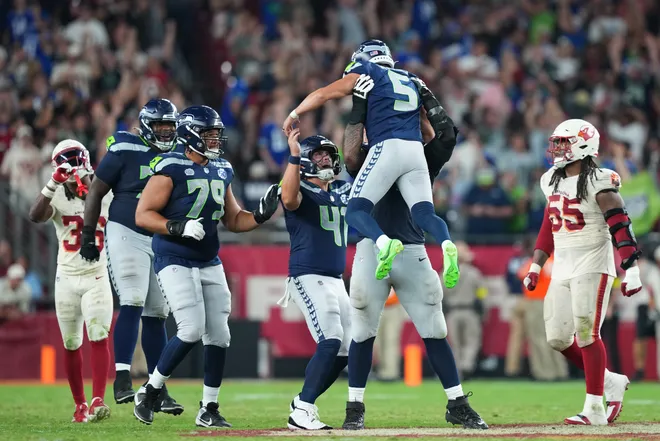 Seattle Seahawks' Jason Myers celebrates with long snapper Chris Stoll and teammates after kicking a game-winning field goal against the Arizona Cardinals.