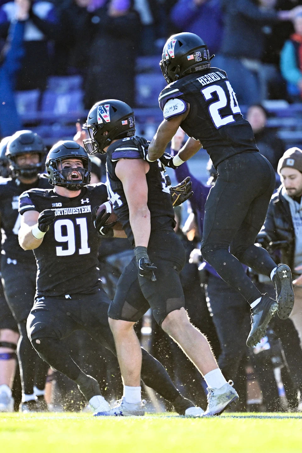 <p>Nov 18, 2023; Evanston, Illinois, USA; Northwestern Wildcats linebacker Xander Mueller (34), center, celebrates with defensive lineman Aidan Hubbard (91) and defensive back Rod Heard II (24) after intercepting a Purdue Boilermakers pass in the fourth quarter at Ryan Field. Mandatory Credit: Jamie Sabau-Imagn Images</p>