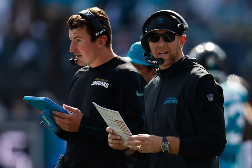 Jacksonville Jaguars offensive coordinator Grant Udinski, left listens on the headset as Jacksonville Jaguars head coach Liam Coen call a play during the first quarter in an NFL football AFC Wild Card playoff matchup, Sunday, Jan. 11, 2026, in Jacksonville, Fla. Bills lead 10-7 at the half over the Jaguars. [Doug Engle/Florida Times-Union]