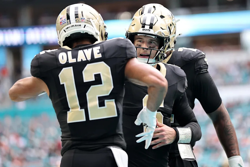 MIAMI GARDENS, FLORIDA - NOVEMBER 30: Chris Olave #12 of the New Orleans Saints celebrates with Tyler Shough #6 after his touchdown reception against the Miami Dolphins during the third quarter at Hard Rock Stadium on November 30, 2025 in Miami Gardens, Florida. (Photo by Carmen Mandato/Getty Images)