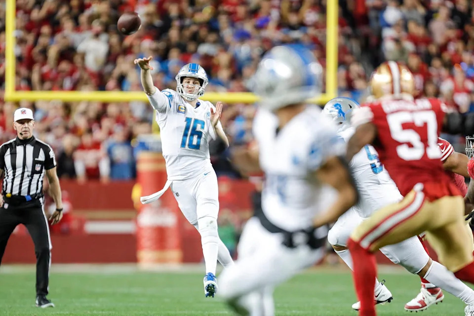 Lions quarterback Jared Goff makes a pass toward receiver Amon-Ra St. Brown.