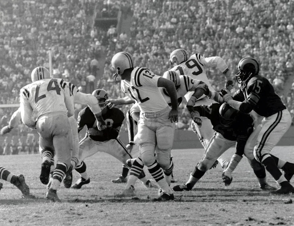 John Brodie hands the ball off to running back J.D. Smith (24) during the 1961 season.