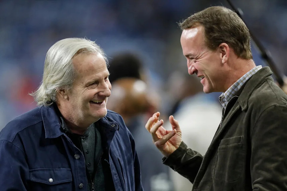 Jeff Daniels talks to Peyton Manning at warm up before the NFC divisional round at Ford Field in Detroit on Sunday, Jan, 21, 2024.