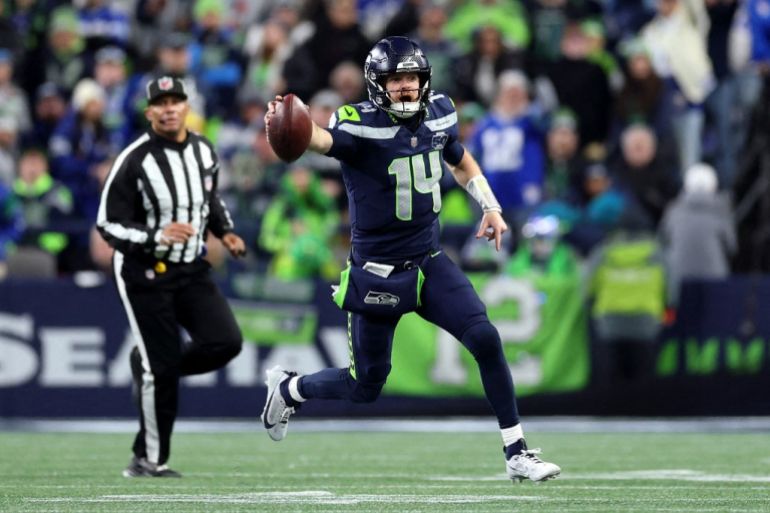 SEATTLE, WASHINGTON - JANUARY 25: Sam Darnold #14 of the Seattle Seahawks runs for a first down against the Los Angeles Rams in the NFC Championship game at Lumen Field on January 25, 2026 in Seattle, Washington. Steph Chambers/Getty Images/AFP (Photo by Steph Chambers / GETTY IMAGES NORTH AMERICA / Getty Images via AFP)