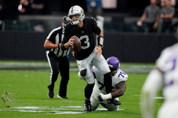 Las Vegas Raiders quarterback Jarrett Stidham is tackled by Minnesota Vikings defensive tackle T.Y. McGill.
