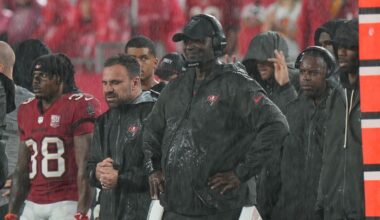 Tampa Bay Buccaneers head coach Todd Bowles watches the action in the rain during an NFL football game against the Carolina Panthers, Sunday, Jan 3, 2026, in Tampa, Fla. (AP Photo/Peter Joneleit)