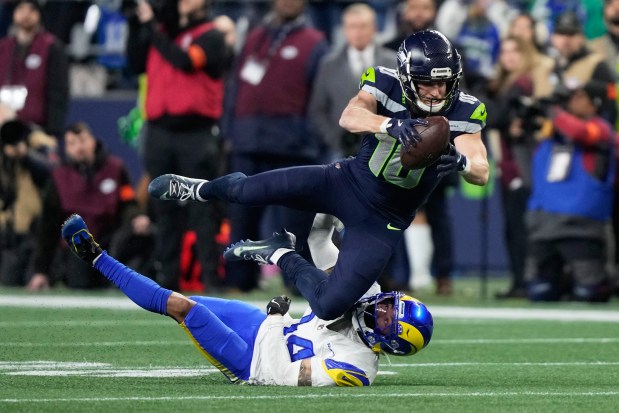Seattle Seahawks wide receiver Cooper Kupp (10) leaps over Los Angeles Rams cornerback Cobie Durant (14) after a catch during the second half of the NFC Championship NFL football game Sunday, Jan. 25, 2026, in Seattle. (AP Photo/Stephen Brashear)