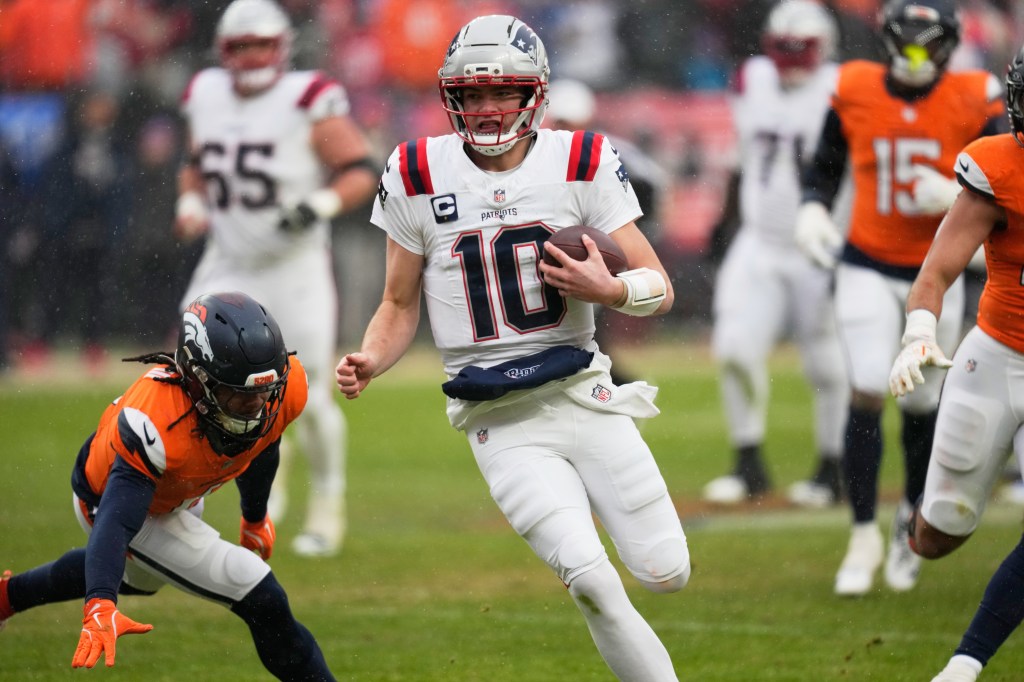 New England Patriots quarterback Drake Maye runs against the Denver Broncos during the second the half of the AFC Championship NFL football game, Sunday, Jan. 25, 2026, in Denver. 