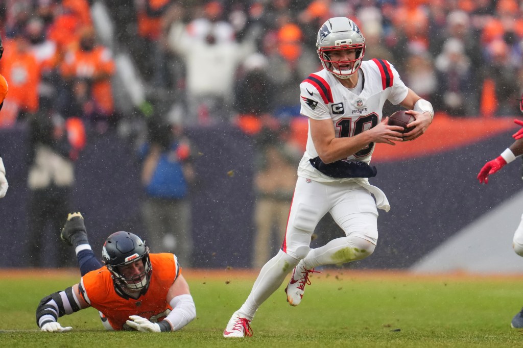 New England Patriots quarterback Drake Maye runs against the Denver Broncos during the second the half of the AFC Championship NFL football game, Sunday, Jan. 25, 2026, in Denver. 