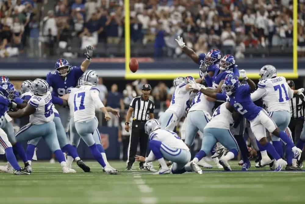 Vikings football team attempting to catch a football during a game against the Dallas Cowboys.