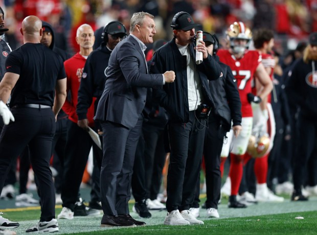San Francisco 49ers head coach Kyle Shanahan talks with general manager John Lynch in the final seconds of their game against the Chicago Bears in the fourth quarter at Levi's Stadium in Santa Clara, Calif., on Sunday, Dec. 28, 2025. (Nhat V. Meyer/Bay Area News Group)