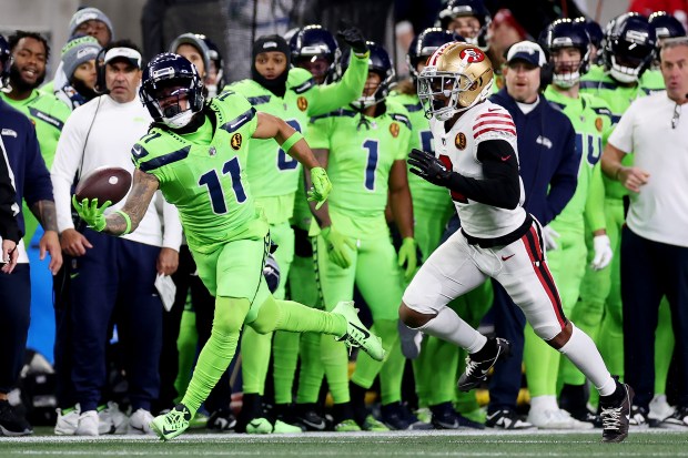 SEATTLE, WASHINGTON - NOVEMBER 23: Jaxon Smith-Njigba #11 of the Seattle Seahawks hauls in a one-handed catch in front of Deommodore Lenoir #2 of the San Francisco 49ers during the third quarter at Lumen Field on November 23, 2023 in Seattle, Washington. (Photo by Steph Chambers/Getty Images)