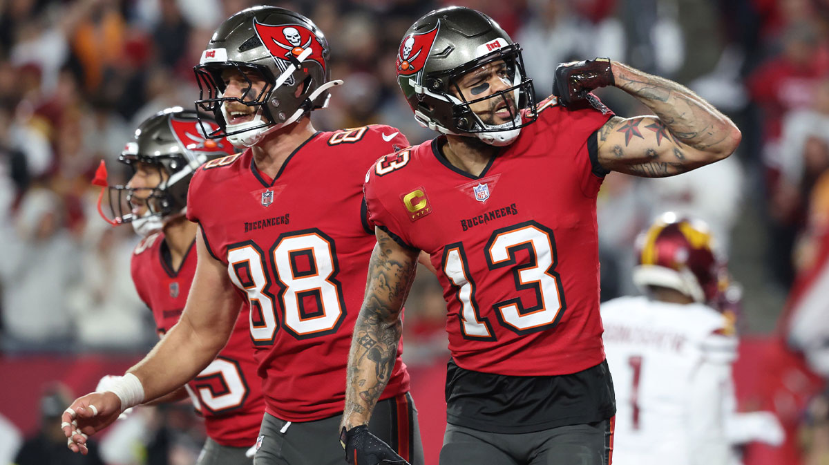 Tampa Bay Buccaneers wide receiver Mike Evans (13) celebrates after a touchdown catch with tight end Cade Otton (88) during the second quarter of a NFC wild card playoff against the Washington Commanders at Raymond James Stadium.
