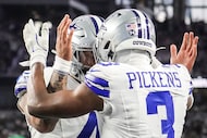 Dallas Cowboys wide receiver George Pickens (3) celebrates with quarterback Dak Prescott...