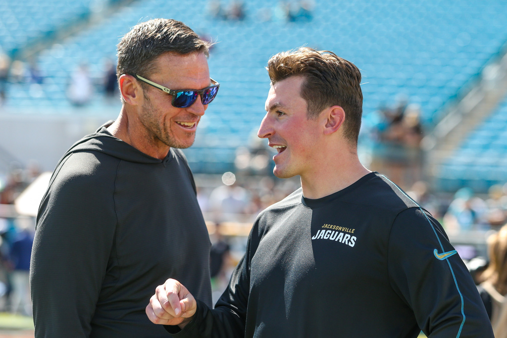 Jacksonville Jaguars Executive Vice President of Football Operations Tony Boselli and offensive coordinator Grant Udinski, right, talk on the field before an NFL football game against the Seattle Seahawks, Sunday, Oct. 12, 2025, in Jacksonville, Fla. The Seahawks defeated the Jaguars 20-12.