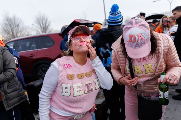 From left, Jennifer Fales and Jamie Binder wear pink sweaters and mustaches while tailgating before the Chicago Bears play the Detroit Lions at Soldier Field Sunday Jan. 4, 2026 in Chicago. (Armando L. Sanchez/Chicago Tribune)