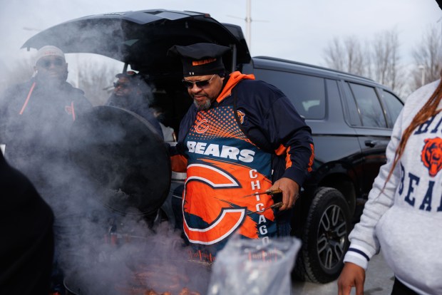 Clarence Griggs grills while tailgating before the Chicago Bears play the Detroit Lions at Soldier Field Sunday Jan. 4, 2026 in Chicago. (Armando L. Sanchez/Chicago Tribune)