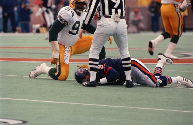 Green Bay Packers Charles Martin (94) checks his victim after slamming Bears quarterback Jim McMahon to the ground during a Nov. 23, 1986 game in Soldier Field. The play occurred after a Packer interception in the second quarter. Referee Jerry Markbreit (9), who witnessed the act from a few feet away, assessed a 15-yard penalty to the Packers and ejected Martin. McMahon was out for the season after the hit. The Bears won the game, however, 12-10. (Edward Wagner/Chicago Tribune)