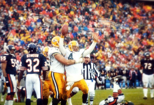 Green Bay Packers quarterback Brett Favre (4) celebrates his fourth-quarter touchdown run as Packers tackle Ken Ruettgers (75) gives him a hug on Nov. 22, 1992 in Chicago. At left is Chicago Bears cornerback Lemuel Stinson.The Packers beat the Bears 17-3 at Soldier Field. (Fred Jewell/AP)