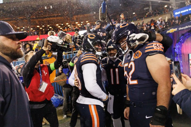 Chicago Bears quarterback Caleb Williams (18) talks with other players before playing the Green Bay Packers in the NFC wild-card game at Soldier Field Jan. 10, 2026, in Chicago. (Armando L. Sanchez/Chicago Tribune)