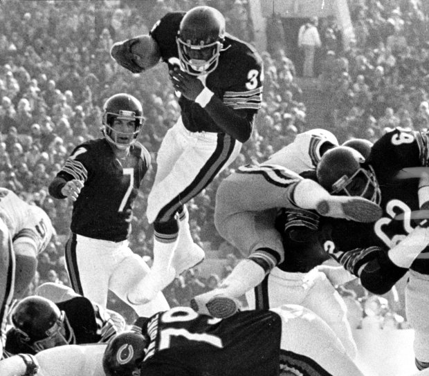 Walter Payton leaps over the Green Bay Packers on Nov. 14, 1976 at Soldier Field in Chicago. Payton broke the 1,000 yard rushing mark for the season and the Bears won 24-13. (Ed Wagner Jr./Chicago Tribune)