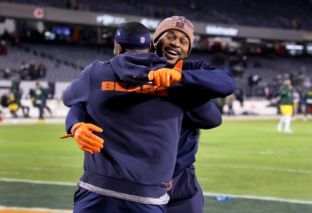 Chicago Bears cornerback Jaylon Johnson (left) and free safety Kevin Byard (right) hug on the field while warming up for a NFC wild-card game against the Green Bay Packers at Soldier Field in Chicago on Jan. 10, 2026. (Chris Sweda/Chicago Tribune)