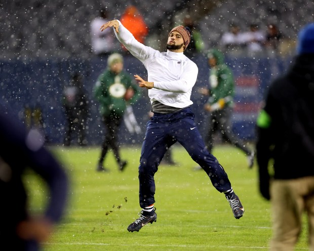 Chicago Bears quarterback Caleb Williams (18) warms up in the snow before a NFC wild-card game against the Green Bay Packers at Soldier Field in Chicago on Jan. 10, 2026. (Chris Sweda/Chicago Tribune)