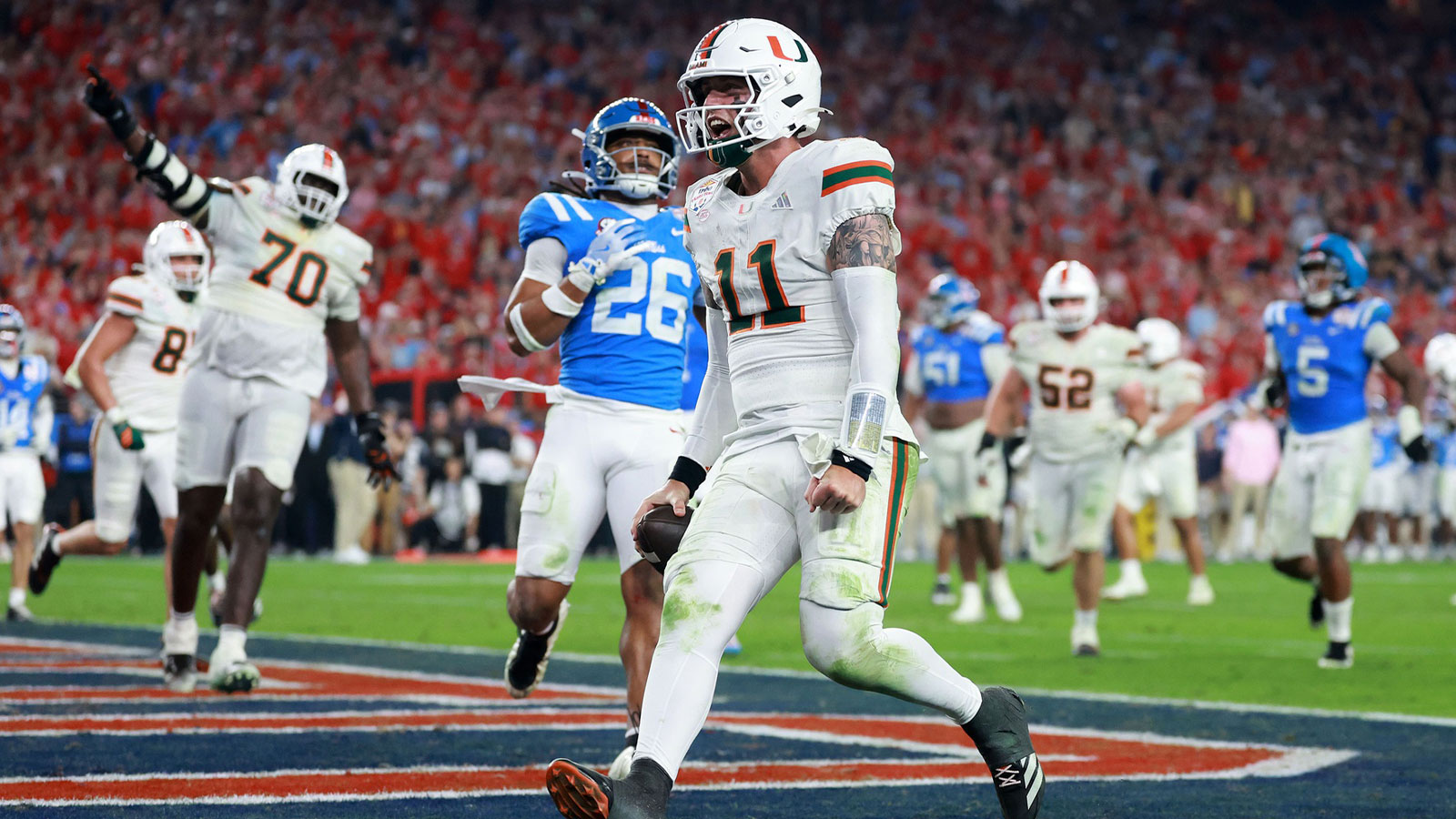 Miami Hurricanes quarterback Carson Beck (11) rushes for a touchdown against the Mississippi Rebels in the second half during the 2026 Fiesta Bowl and semifinal game of the College Football Playoff at State Farm Stadium.
