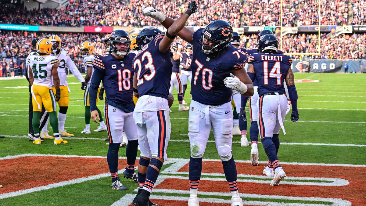 Nov 17, 2024; Chicago, Illinois, USA; Chicago Bears running back Roschon Johnson (23) celebrates his rushing touchdown with offensive tackle Braxton Jones (70) against the Green Bay Packers during the second quarter at Soldier Field. Mandatory Credit: Daniel Bartel-Imagn Images