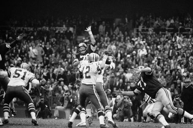 Cowboys quarterback Roger Staubach rears back to pass 22 yards to Ron Sellers on a third-down play late in the second quarter of the NFC championship game against Washington on Dec. 31, 1972. (AP)