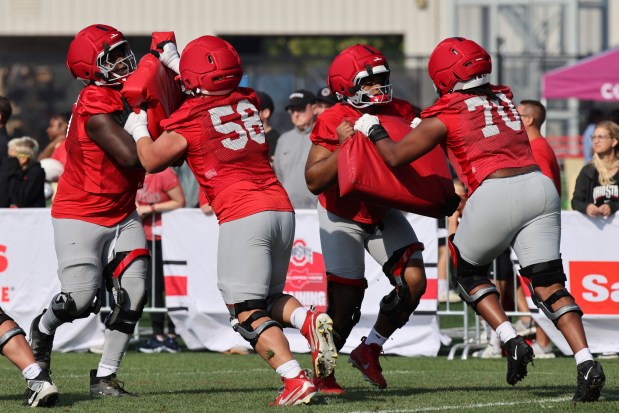 Ohio State offensive lineman Justin Terry, left, Gabe VanSickle, Jayvon McFadden, and Phillip Daniels participate in a drill during NCAA college football practice in Columbus, Ohio, Friday, Aug. 1, 2025. (AP Photo/Paul Vernon)