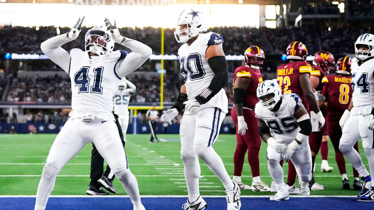 Dallas Cowboys defensive end Donovan Ezeiruaku (41), with defensive end Solomon Thomas (90) approaching, reacts after recording a sack against Washington Commanders quarterback Marcus Mariota (8) during the second half of an NFL football game Sunday, Oct. 19, 2025, in Arlington, Texas. (AP Photo/Jeffrey McWhorter)