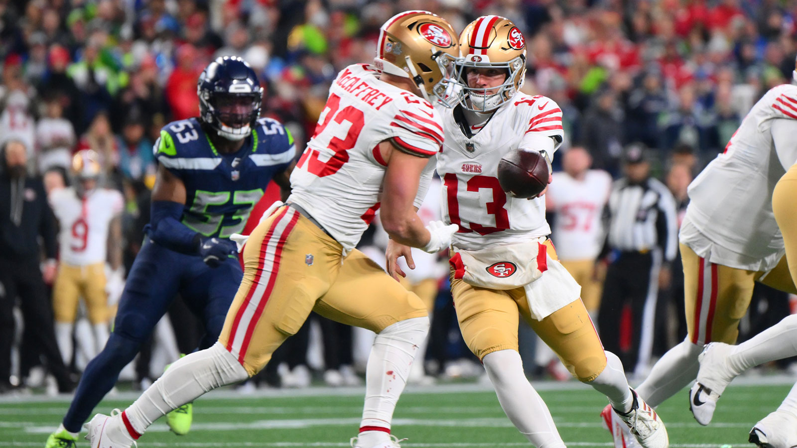 San Francisco 49ers quarterback Brock Purdy (13) hands off to running back Christian McCaffrey (23) against the Seattle Seahawks during the first half in an NFC Divisional Round game at Lumen Field. Mandatory Credit: Steven Bisig-Imagn Images
