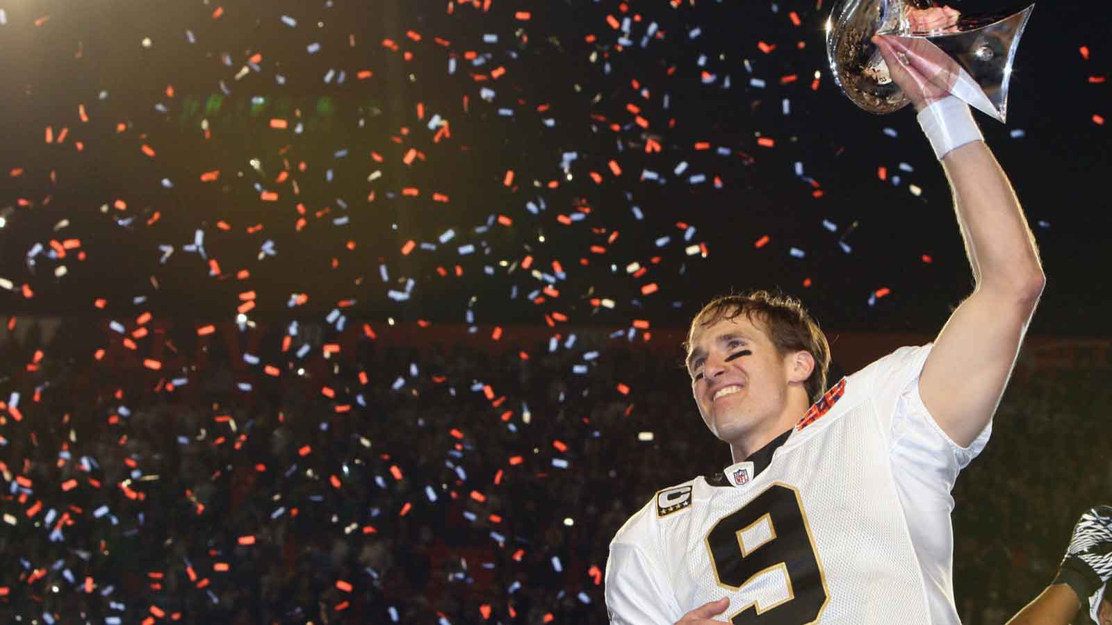 New Orleans Saints quarterback Drew Brees (9) hoists the Lombardi Trophy after defeating the Indianapolis Colts 31-17 in Super Bowl XLIV at Sun Life Stadium. 